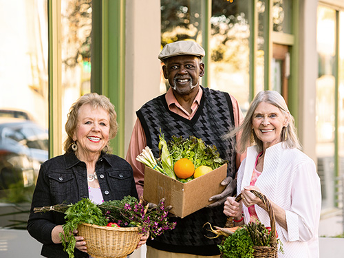 Active adults enjoy a local farmers market>